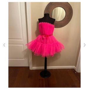 Hot pink, strapless, tulle, cocktail dress with bow belt.